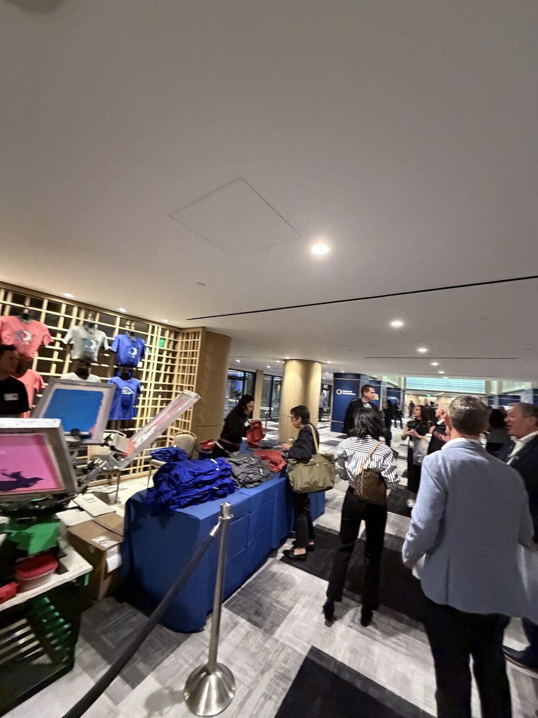 Corporate event booth with branded backdrop and merch counter